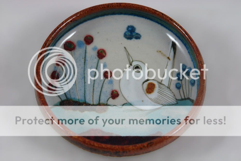 small pottery dih with bird decoration