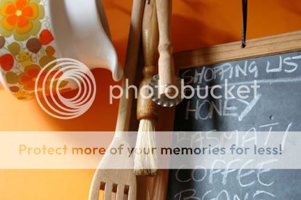 photo of a child's writing slate and wooden kitchen utensils