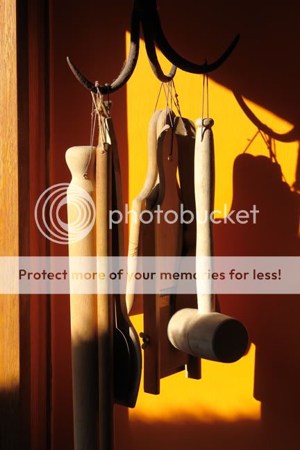 group of utensils hanging from antique iron well hook